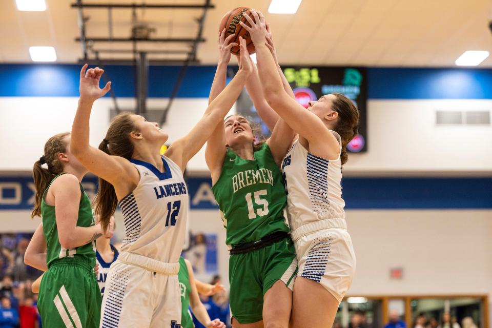 Bremen's Emma Kincaid (15) and LaVille's Lucy Sherk (25) battle for the rebound during the Bremen-LaVille high school Bi-County championship basketball game on Saturday, January 21, 2023, at LaVille High School in Lakeville, Indiana.