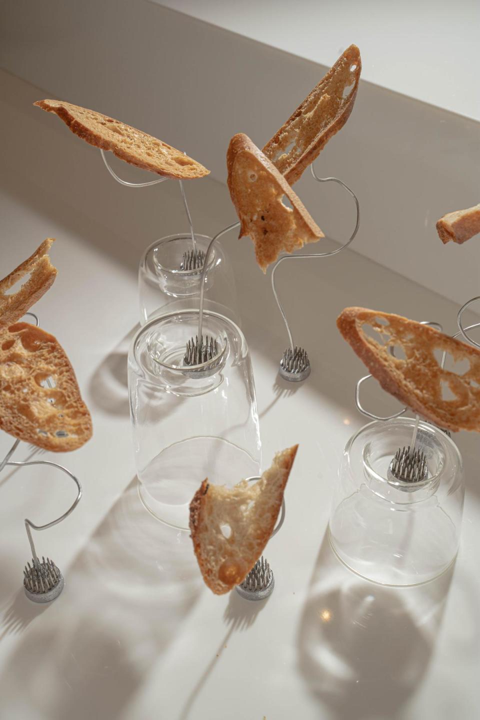 吧台的裝置藝術，以Moon Baking Studio的麵包結合台玻TG玻璃燭台與回收的插花劍山，呈現錯落層次。（The Seedin Lab提供）