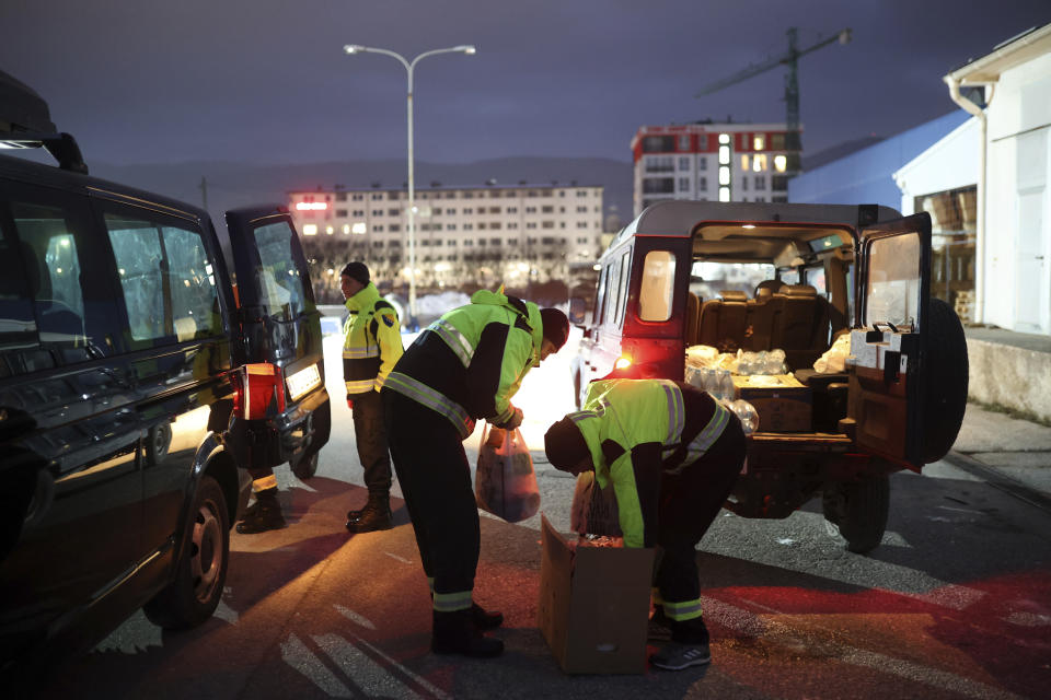 Rescuers from Bosnia's mountain rescue services prepare food packages prior to their departure from Sarajevo, Bosnia, Tuesday, Feb. 7, 2023. Team of 25 men and women left from Sarajevo to Turkey after devastating earthquake with more than 6000 casualties. (AP Photo/Armin Durgut)