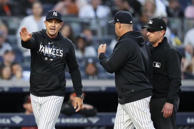 New York Yankees manager Aaron Boone, left, argues with umpire Chris Guccione, right, after Boone was ejected during the third inning of the team's baseball game against the Baltimore Orioles on Thursday, May 25, 2023, in New York. (AP Photo/Frank Franklin II)