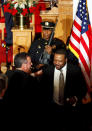 New Jersey Gov. Chris Christie shakes hugs Pastor Joe Carter after a prayer service in celebration of his inauguration at the New Hope Baptist Church on Tuesday, Jan. 21, 2014 in Newark. The celebrations to mark the start of Christie's second term could be tempered by investigations into traffic tie-ups that appear to have been ordered by his staff for political retribution and an allegation that his administration linked Superstorm Sandy aid to approval for a real estate project. (AP Photo/Rich Schultz)