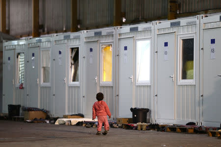 A migrant child is seen in a migrant camp in Bihac, Bosnia and Herzegovina, December 14, 2018. REUTERS/Antonio Bronic