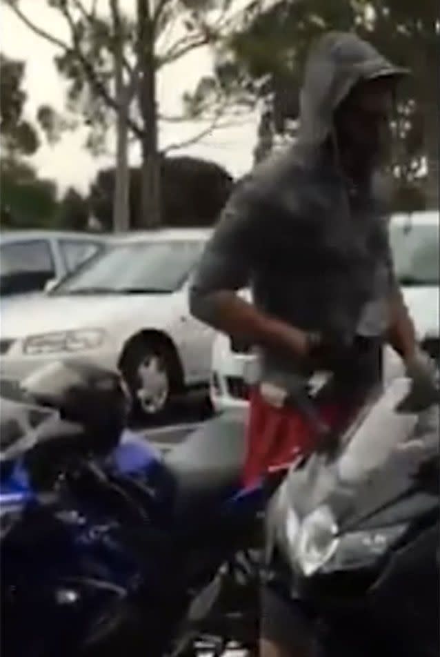 The thief is caught on camera tinkering with the bike's steering lock with a spanner. Picture: Facebook/Thomastown 3074