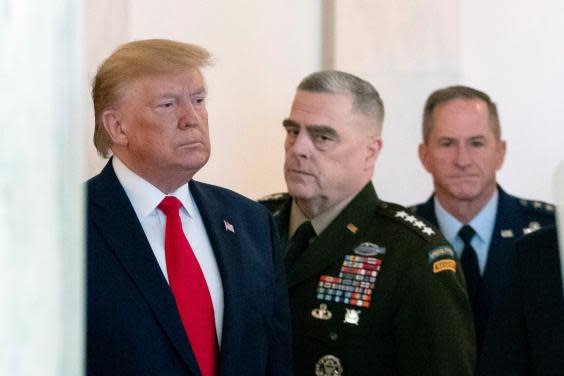 Donald Trump, flanked by Mark Milley, chairman of the joint chiefs of staff, centre, and David Goldfein, Air Force chief of staff, right, prepares to read a statement on tensions with Iran (AP)