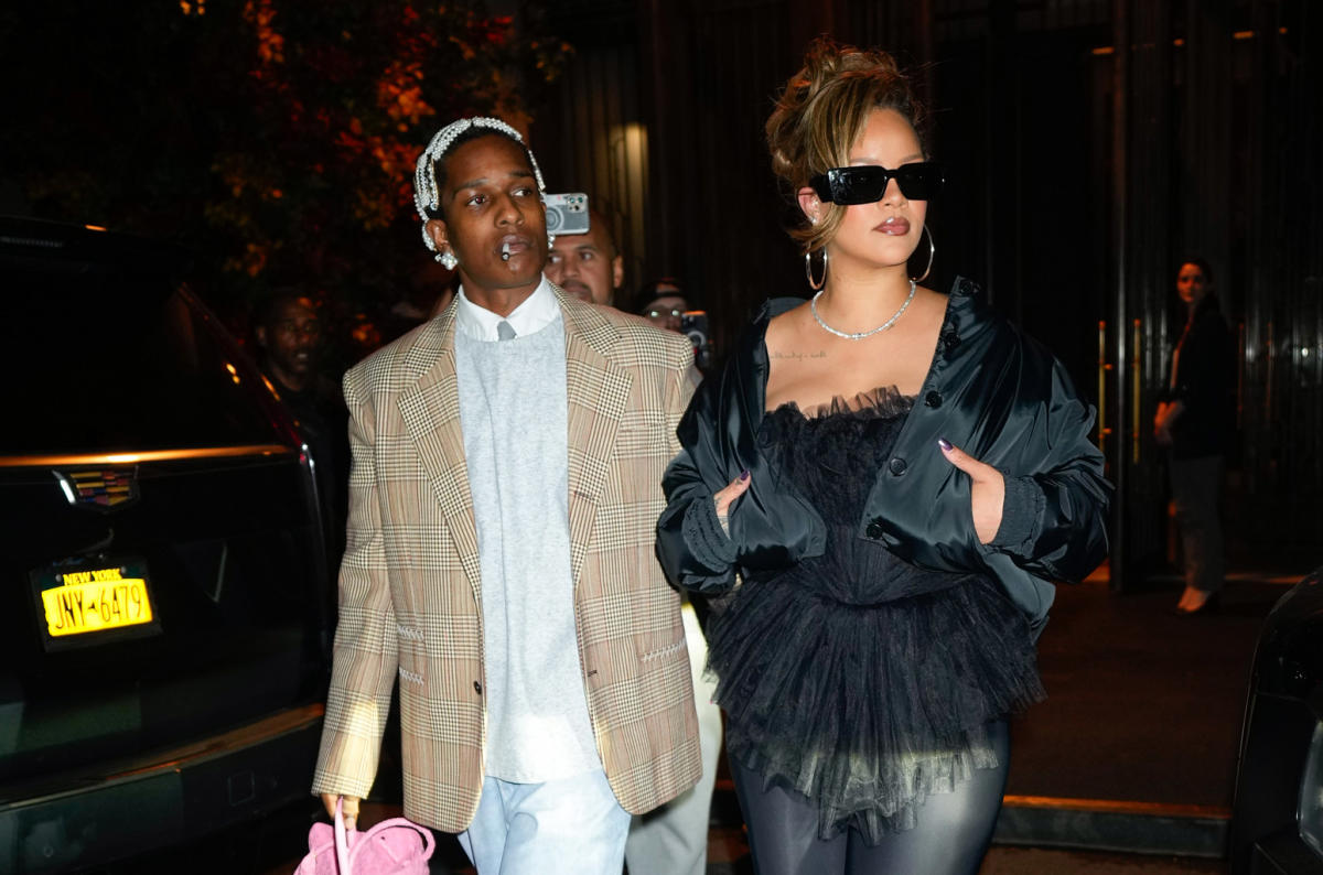 Rihanna's partner A$AP Rocky carries an orange purse