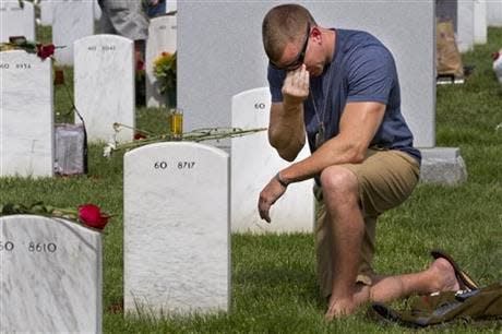 Former Army Sgt. Anthony Brown, 31, of Arlington, Va., wipes away tears as he visits his best friend, Army Sgt. Scott Kirkpatrick, on Memorial Day at Arlington National Cemetery in Arlington, Va. in this 2014 file photo. Kirkpatrick died serving in Iraq in 2007 at the age of 27, and is buried in Section 60, where many of the soldiers who died in Iraq and Afghanistan are buried.