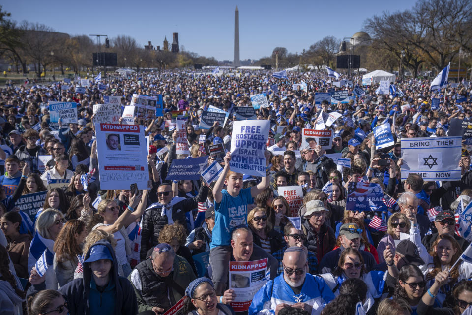 Participants hold signs as they stand on the National Mall at the March for Israel on Tuesday, Nov. 14, 2023, in Washington. (AP Photo/Mark Schiefelbein)