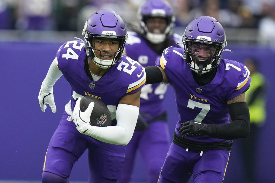 Minnesota Vikings' Camryn Bynum, left, celebrates an interception during the first half of an NFL football game against the New York Jets, Sunday, Oct. 6, 2024, at the Tottenham Hotspur stadium in London. (AP Photo/Kirsty Wigglesworth)