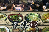 People are seen in the window eating at a Chinese restaurant decorated with menu items on its shop front on Friday Jan. 10, 2020, in New York City. A social media campaign backed by a Japanese seasonings company is targeting the persistent idea that Chinese food is packed with MSG and can make you sick. So entrenched is the notion in American culture, it shows up in the dictionary: Merriam-Webster.com lists “Chinese restaurant syndrome." as a real illness. But much of the mythology around the idea has been debunked: monosodium glutamate, also known as MSG, shows up in many foods from tomatoes to breast milk, and there's no evidence to link it to illness. (AP Photo/Wong Maye-E)