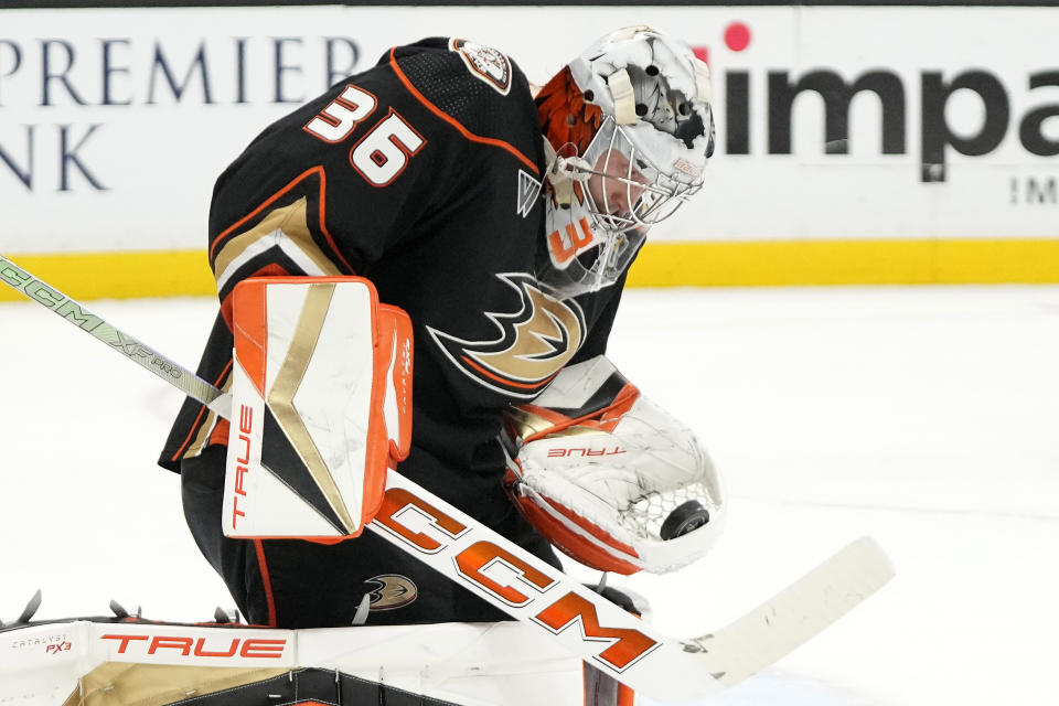 Anaheim Ducks goaltender John Gibson makes a glove save during the second period of an NHL hockey game against the Arizona Coyotes Friday, Dec. 29, 2023, in Anaheim, Calif. (AP Photo/Mark J. Terrill)