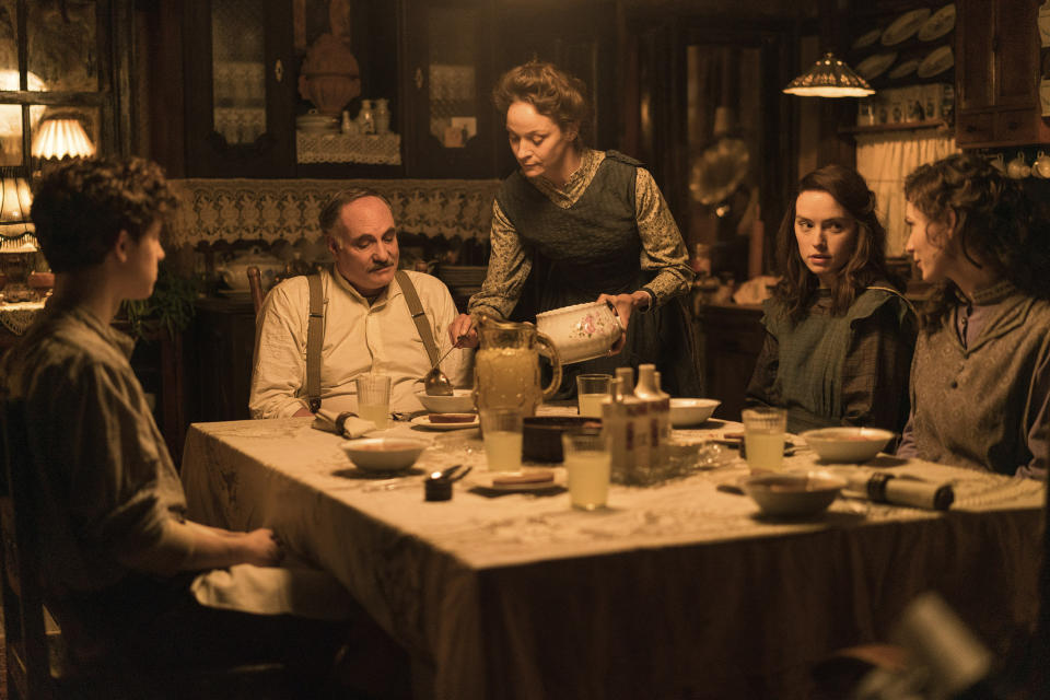 This image released by Disney shows Kim Bodnia as Henry Ederle, Jeanette Hain as Gertrud Ederle, Daisy Ridley as Trudy Ederle in a scene from "Young Woman and the Sea." (Vladisav Lepoev/Disney via AP)