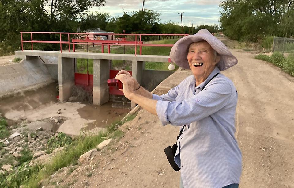 Penny Duncklee snaps a photo at an arroyo near her house. Duncklee was mauled by two dogs in this location on March 16, 2022.