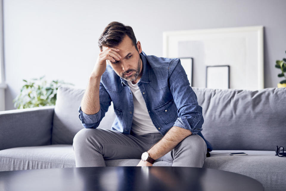 a frustrated man on a couch