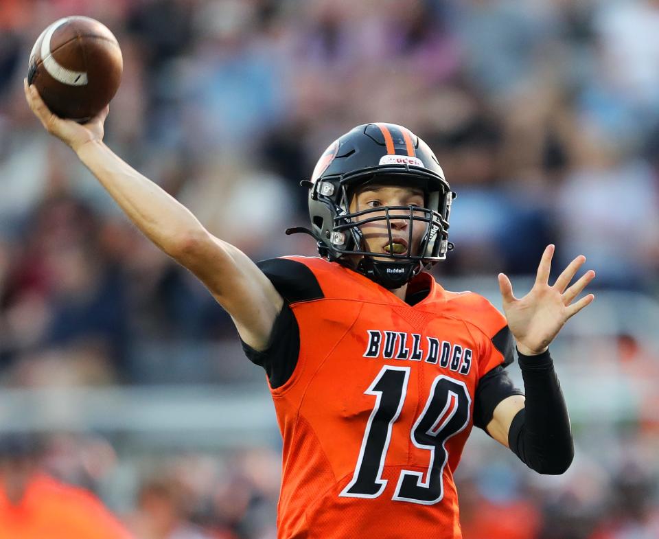 Green quarterback Robby Klockner looks to throw a pass during the first half of a high school football game against the Ellet Orangemen, Friday, Aug. 19, 2022, in Green, Ohio.