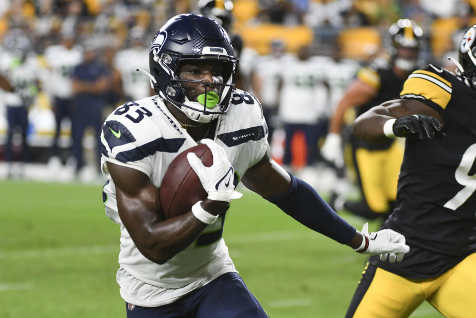 Seattle Seahawks wide receiver Dareke Young (83) runs past Pittsburgh Steelers linebacker Mark Robinson, right, during the second half of a preseason NFL football game, Saturday, Aug. 13, 2022, in Pittsburgh. (AP Photo/Fred Vuich)