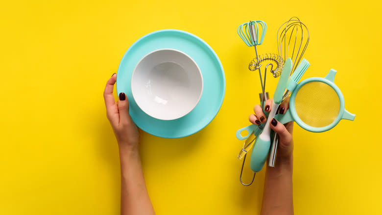 Person holding assorted baking tools