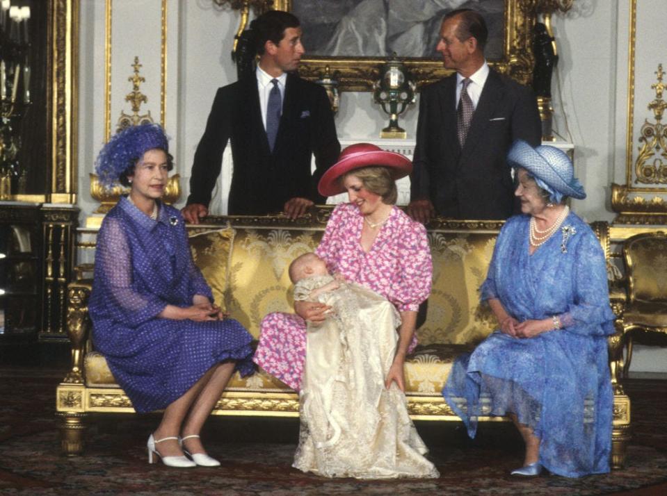 <p>Princess Diana smiles as she holds her son, Prince William, surrounded by family at the baby's christening.</p>