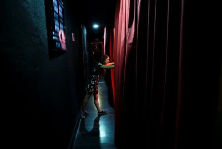 A theatre staff member stands in the hallway before a performance at Microteatro Por Dinero (Microtheatre for money) in central Madrid, Spain September 2, 2016. Picture taken September 2, 2016. REUTERS/Andrea Comas