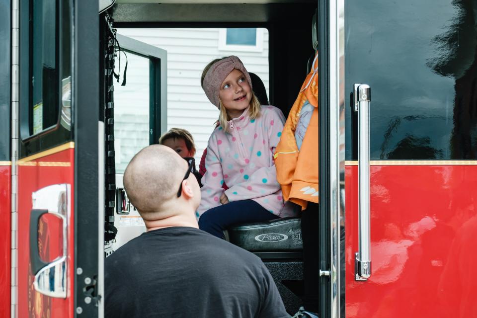 People examine the interior of New Philadelphia's new fire truck, Ladder 2109, during the official push-in ceremony Saturday.