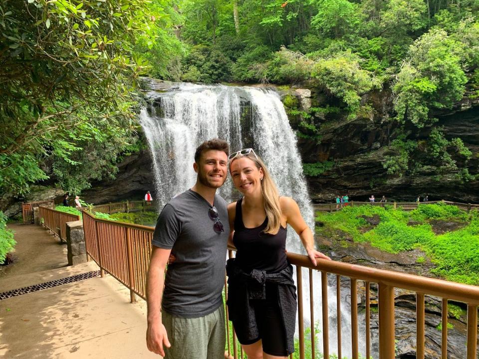 Strong and her fiance in front of dry falls in highlands nc
