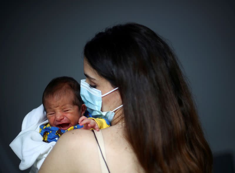 FILE PHOTO: Emmanuelle Lteif Khnaisser who was in labour at the moment of the Beirut port blast, holds her baby George at the family home in Jal el-Dib