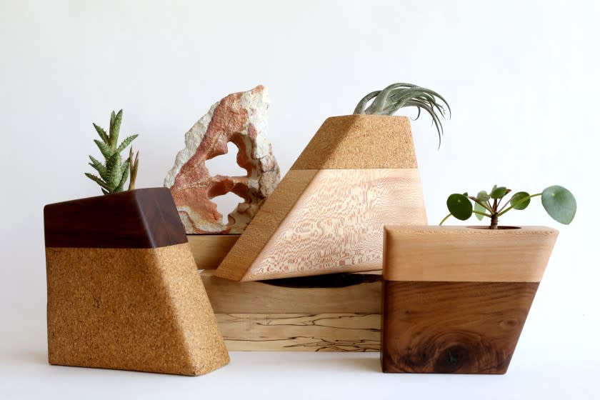 LOS ANGELES, CA - JULY 09: C.C. Boyce, 47, creates "Planturns" - custom-made wood urns for cremation remains, in her studio in the garment district, on Friday, July 9, 2021 in Los Angeles, CA. Left: Walnut top and cork bottom. Center: Cork top and sycamore bottom. Right: Sycamore top and walnut bottom. Boyce's urns, which can be used for both pets and people, are unique in that they can be used as planters. C.C. is founder of Boyce Studio in the garment district downtown. (Gary Coronado / Los Angeles Times)