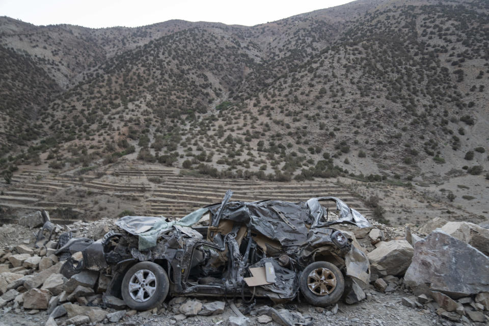 A car heavily damaged by the earthquake is left on the side of a road on the way to Ijjoukak village, near Marrakech, Morocco, Saturday, Sept. 9, 2023. A rare, powerful earthquake struck Morocco late Friday night, killing hundreds of people and damaging buildings from villages in the Atlas Mountains to the historic city of Marrakech. But the full toll is not known as rescuers struggled to get through boulder-strewn roads to the remote mountain villages hit hardest. (AP Photo/Mosa'ab Elshamy)