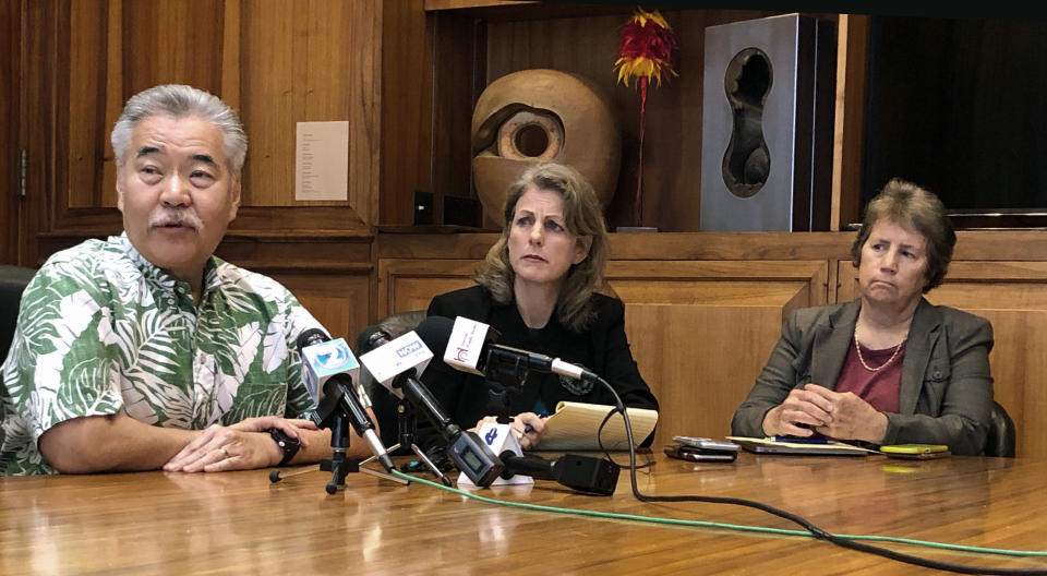 Hawaii Gov. David Ige, left, speaks to reporters in Honolulu on Thursday, Dec. 19, 2019, about police standing-down from a mountain where protesters are blocking construction of a giant telescope, as state Attorney General Clare Connors, middle, and state Department of Land and Natural Resources Chairwoman Suzanne Case, right, look on. Ige says builders of the Thirty Meter Telescope aren't going to move forward for now with construction, so he's removing law enforcement from the mountain. (AP Photo/Jennifer Sinco Kelleher).