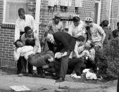 <p>Injured demonstrators are tended to after state police broke up a march in Selma, Ala., on March 7, 1965, the day that became known as “Bloody Sunday.” Images and news articles about the clash are credited with helping pass the Voting Rights Act later that year. (Photo: AP) </p>