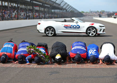 May 28, 2017; Indianapolis, IN, USA; IndyCar Series driver Takuma Sato and crew kiss the bricks as he celebrates after winning the 101st Running of the Indianapolis 500 at Indianapolis Motor Speedway. Mandatory Credit: Mark J. Rebilas-USA TODAY Sports