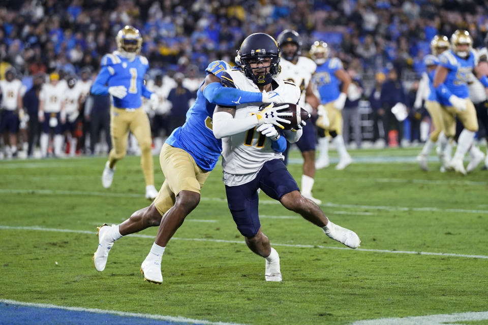 UCLA defensive back Quentin Lake, left, stops California wide receiver Kekoa Crawford short of the end zone during the first half of an NCAA college football game Saturday, Nov. 27, 2021, in Pasadena, Calif. (AP Photo/Jae C. Hong)