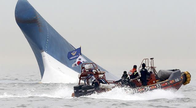 South Korean coast guard officers try to rescue passengers from a ferry sinking in the water off the southern coast near Jindo, south of Seoul, South Korea. Photo: AP.