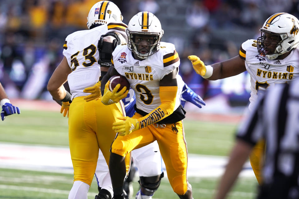 Wyoming safety Alijah Halliburton (3) runs with the football after intercepting a pass during the first half of the Arizona Bowl college football game against Georgia State, Tuesday, Dec. 31, 2019, in Tucson, Ariz. (AP Photo/Rick Scuteri)