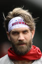 Philadelphia Phillies' Bryce Harper looks on from the dugout before a baseball game against the Washington Nationals, Saturday, April 6, 2024, in Washington. (AP Photo/Nick Wass)