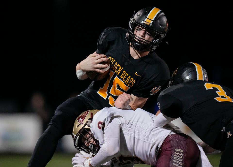 Nov 11, 2022; Westerville, Ohio, USA;  New Albany's Dillon Schaub (3) hits Upper Arlington quarterback Tommy Janowicz (15) in the first half of the Div. I regional semifinal high school football playoff game at Westerville Central. Mandatory Credit: Adam Cairns-The Columbus Dispatch