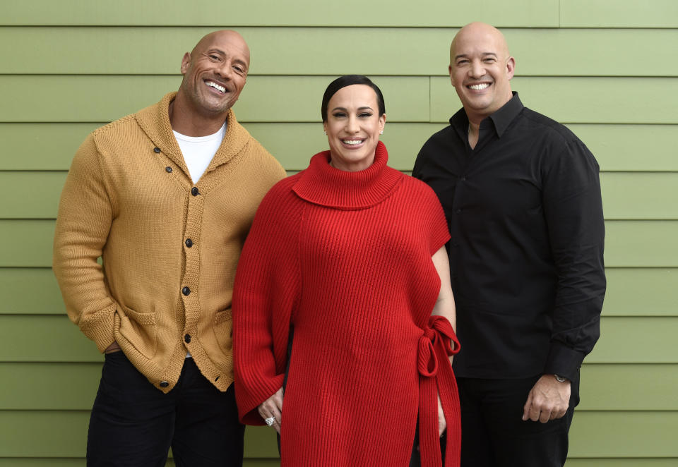 Dwayne Johnson, left, and Dany Garcia, center, co-founders and co-CEOs of Seven Bucks Productions, and her brother Hiram Garcia, the company's president of production, pose together during the 2019 Sundance Film Festival, Monday, Jan. 28, 2019, in Park City, Utah. Johnson put on his independent film producer hat to make his latest film, "Fighting With My Family." (Photo by Chris Pizzello/Invision/AP)
