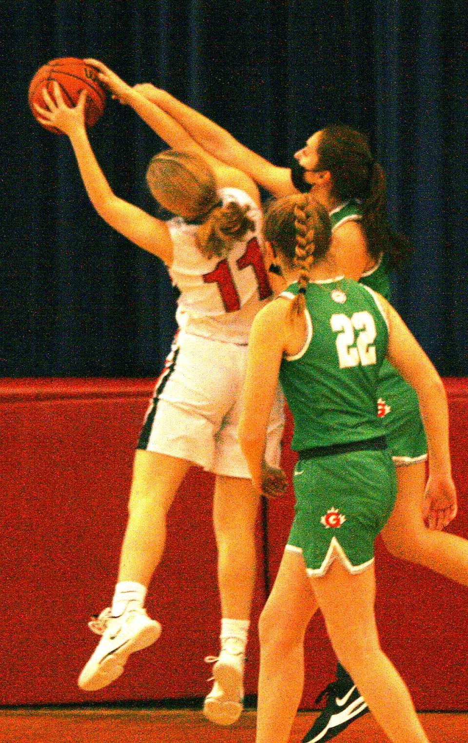 Kewanee junior Lena Miller is fouled as she goes up for the shot.