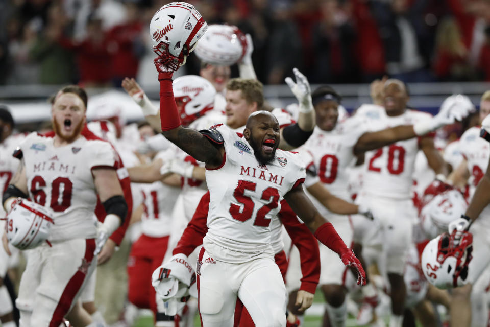 Miami of Ohio defensive lineman Cam Turner (52) leads the team onto the field in celebration after the Mid-American Conference championship NCAA college football game against Central Michigan, Saturday, Dec. 7, 2019, in Detroit. (AP Photo/Carlos Osorio)