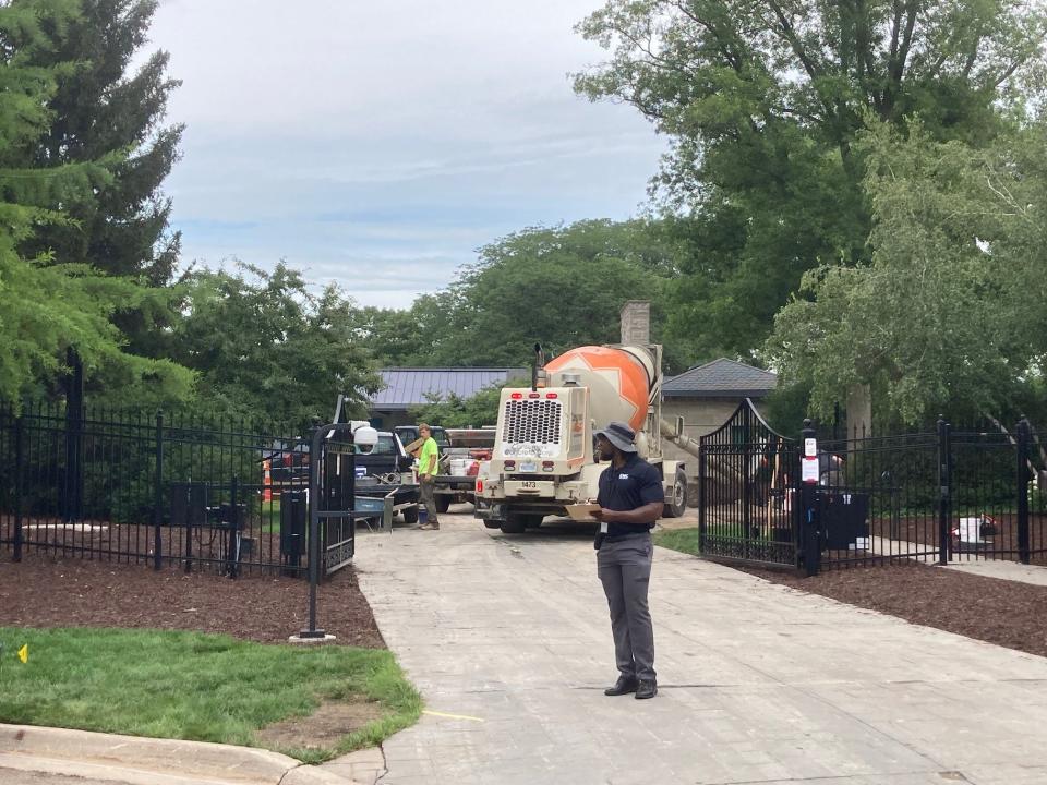 A mixer pours cement Friday at the governor's official residence in Lansing. The driveway replacement project includes two electric vehicle chargers and could cost close to $1 million, records show.