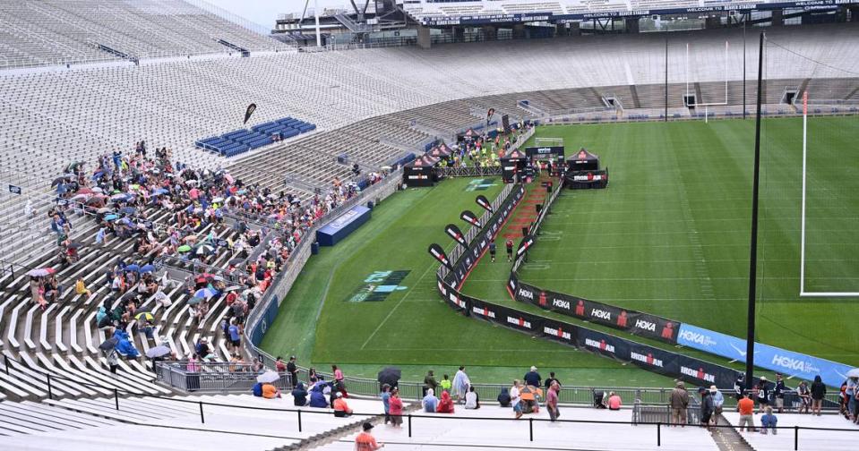 Families and friends of participants in the Ironman 70.3 Pennsylvania Happy Valley watch runners cross the finish line inside Beaver Stadium on Sunday, July 2, 2023. Steve Manuel/For the CDT