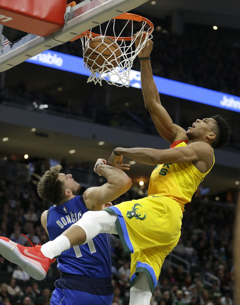 Milwaukee Bucks' Giannis Antetokounmpo dunks against Dallas Mavericks' Luka Doncic during the second half of an NBA basketball game Monday, Jan. 21, 2019, in Milwaukee. (AP Photo/Aaron Gash)