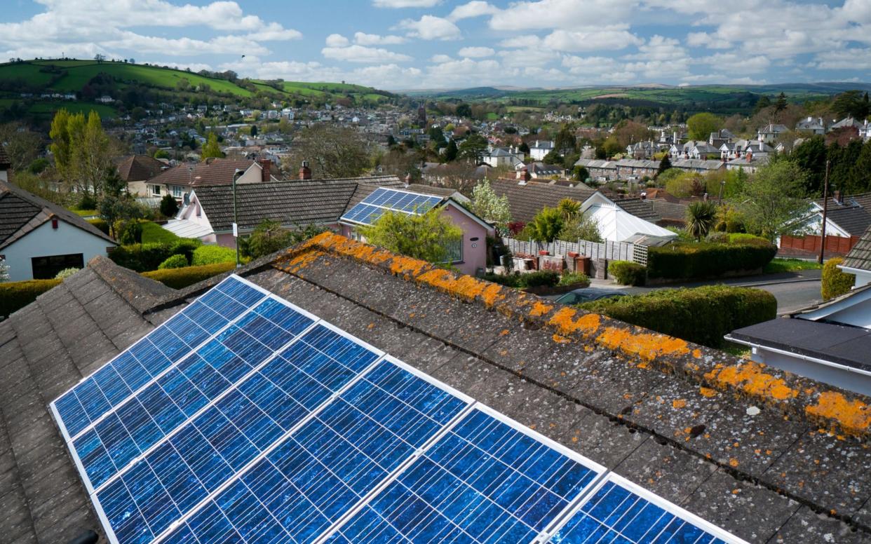 Solar panels on the roof of homes in Devon – but could homeowners be overcharged? - www.Alamy.com