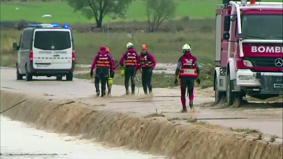 In this image made from video provided by Atlas, firefightters attach ropes to an overturned vehicle in which two people were drowned by floodwater, in Caudete, Spain, Thursday, Sept. 12 2019. A large area of southeast Spain was battered Thursday by what was forecast to be its heaviest rainfall in more than a century, with the storms wreaking widespread destruction and killing at least two people. (Atlas via AP)