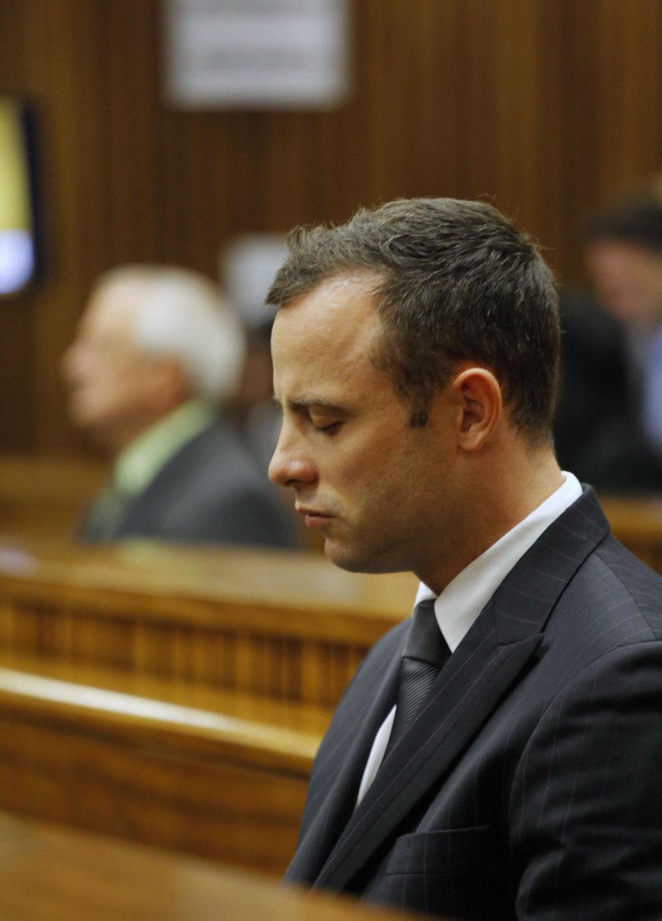 Olympic and Paralympic track star Oscar Pistorius sits in the dock at the North Gauteng High Court in Pretoria March 11, 2014. Pistorius is on trial for murdering his girlfriend Reeva Steenkamp at his suburban Pretoria home on Valentine's Day last year. REUTERS/Kim Ludbrook/Pool (SOUTH AFRICA - Tags: SPORT CRIME LAW)