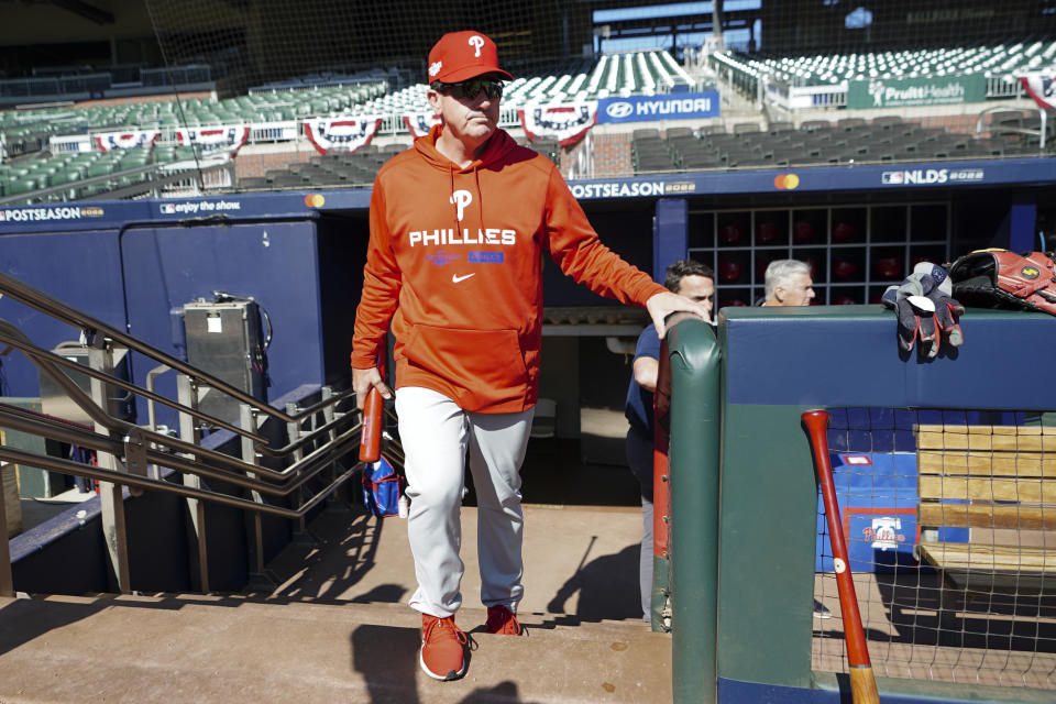 Philadelphia Phillies manager Rob Thomson steps out of the dugout for a workout ahead of Game One of the National League Division baseball playoff game against the Atlanta Braves, Monday, Oct. 10, 2022, in Atlanta. (AP Photo/John Bazemore)