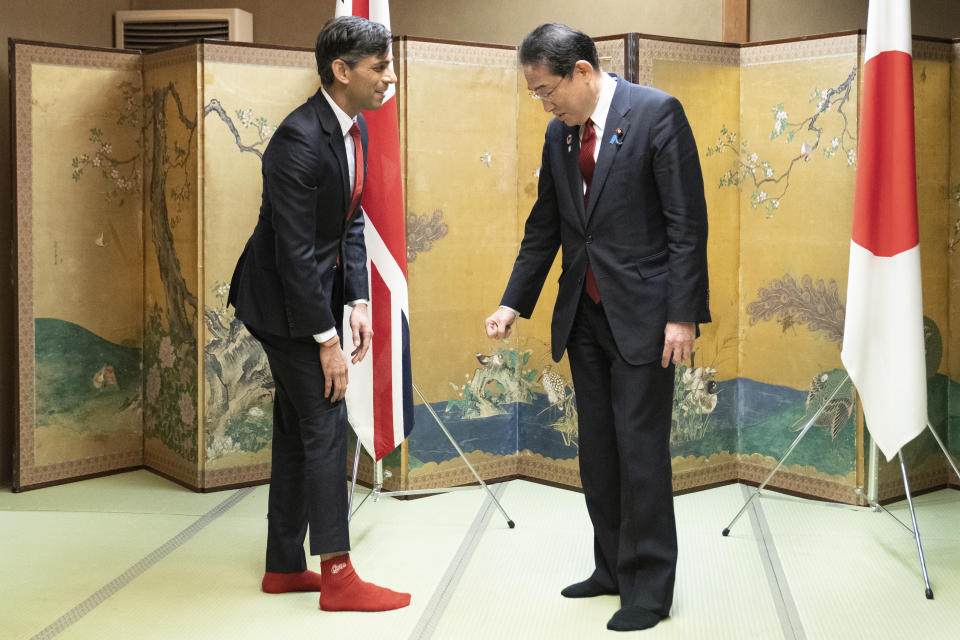 XFP British Prime Minister Rishi Sunak shows off his socks to Japanese Prime Minister Fumio Kishida, which has the name of Kishida's favorite baseball team, Hiroshima Toyo Carp, on them, during their bilateral meeting in Hiroshima ahead of the G7 Summit in Japan, Thursday May 18, 2023. (Stefan Rousseau, Pool via AP)