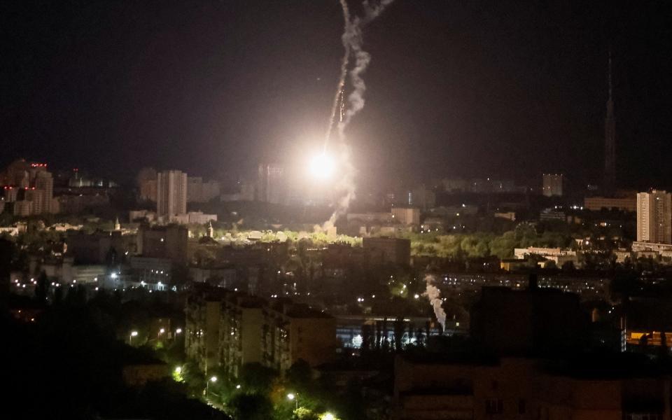 Explosion of a missile is seen in the sky over the city during a Russian missile strike - GLEB GARANICH/REUTERS