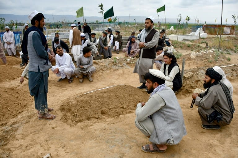 Afghan relatives offer prayers during a burial ceremony for a victim of flash floods in Baghlan province, Afghanistan, where hundreds of people have been killed by surging waters that followed torrential rainfall (Atif Aryan)