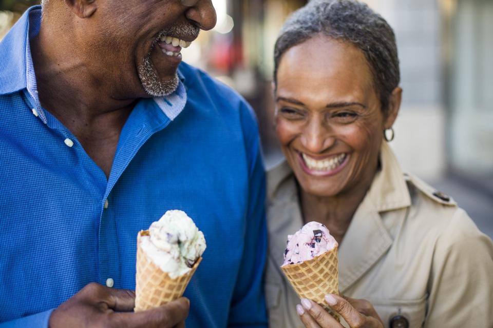 african american senior couple on the town with ice cream