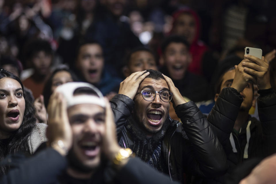 Moroccan fans react while watching the Morocco national team lose to France in the semi final of the World Cup played in Qatar, in Rabat, Morocco, Wednesday, Dec. 14, 2022. (AP Photo/Mosa'ab Elshamy)